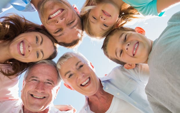 Family of three generations all smiling